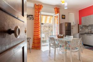 a kitchen with a table and chairs in a kitchen at Leondoro - Pirandello in Santa Flavia