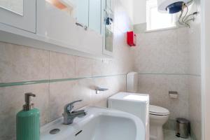 a bathroom with a sink and a toilet at Leondoro - Pirandello in Santa Flavia +17 photos