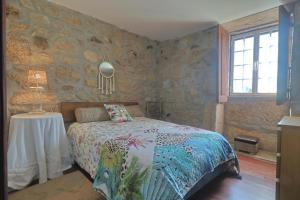 a bedroom with a bed and a table with a lamp at Casa De Vilar do Dão in Penalva do Castelo +36 photos