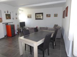 a living room with a table and chairs and a couch at Maison de Village in Puimoisson