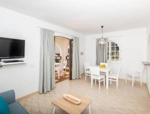 a living room with a table and a dining room at Girasol Garden Superior 2-a in Menorca