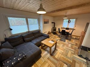 a living room with a couch and a table at Ferienhaus Haffstille in Ueckermünde