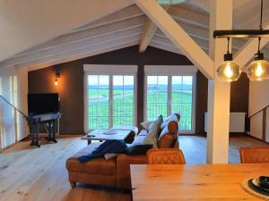 a living room with a couch and a piano at Hof Sorgenfrei in Buch