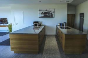 a kitchen with a counter with a sink and a counter top at Ferienhaus mit Panoramablick in Bühlertal