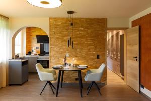 a kitchen and dining room with a table and chairs at Chalet-Sonnengarten in Hinterzarten