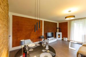 a living room with a couch and a table at Chalet-Sonnengarten in Hinterzarten +36 photos
