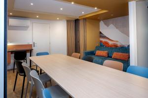 a room with a table and chairs and a bed at La suite des Sommets in Barberaz +18 photos