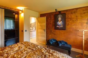 a bedroom with a large bed and a painting on the wall at Chalet-Sonnengarten in Hinterzarten