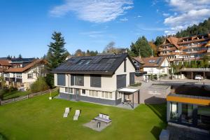 a house with solar panels on the roof at Chalet-Sonnengarten in Hinterzarten