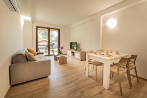 a living room with a table and a couch at Como home residence in Carlazzo