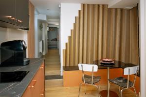 a kitchen with a table and two chairs in a kitchen at La suite des Sommets in Barberaz