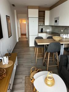 a kitchen and living room with a table and chairs at Bluebell L6 in Armeñime