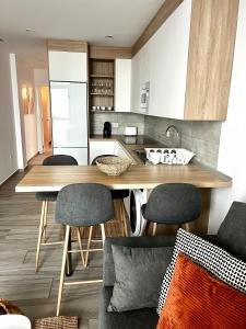 a kitchen with a wooden table and chairs at Bluebell L6 in Armeñime +2 photos