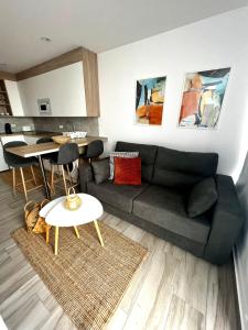 a living room with a couch and a table at Bluebell L6 in Armeñime