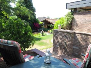 a blue table with chairs and a lantern on a patio at Ferienwohnung Lortz in Cuxhaven