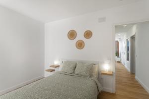 a bedroom with a bed and two mirrors on the wall at Los Mojones in Artenara