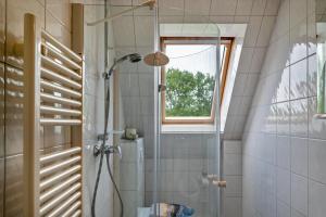a bathroom with a shower with a glass door at Ferienhaus Beckerwitz in Beckerwitz +19 photos