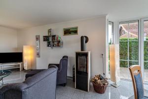 a living room with a couch and a fireplace at Ferienhaus Beckerwitz in Beckerwitz
