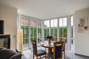 a living room with a table and chairs and a large window at Ferienhaus Beckerwitz in Beckerwitz