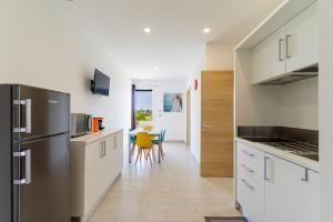 a kitchen with a stainless steel refrigerator and a table at Le scuderie 5 in Galatone
