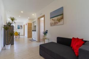 a living room with a couch and a dining room at Le scuderie 5 in Galatone