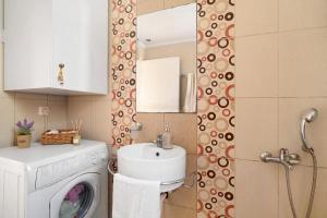 a bathroom with a sink and a washing machine at Villa Ermina Paleros in Paleros