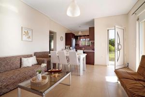 a living room with a couch and a table at Villa Ermina Paleros in Paleros