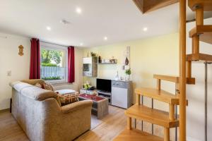 a living room with a couch and a table at Ferienwohung Marion - Hohnstein in Rathewalde