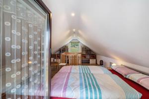 a bedroom with a bed in a attic at Ferienwohung Marion - Hohnstein in Rathewalde