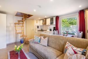 a living room with a couch and a kitchen at Ferienwohung Marion - Hohnstein in Rathewalde