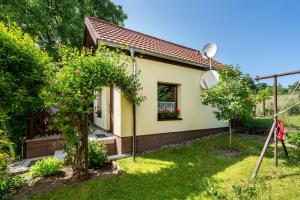 a small yellow house with a window at Ferienwohung Marion - Hohnstein in Rathewalde