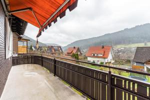 a balcony of a house with a view of a town at Ferienhaus Burghalde mit Sauna in Alpirsbach