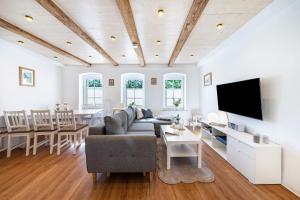 a living room with a couch and a dining room at Ferienhaus1856de mit Sauna in Görlitz