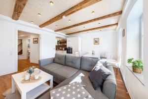 a living room with a couch and a table at Ferienhaus1856de mit Sauna in Görlitz