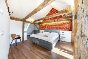 a bedroom with a brick wall and a bed at Ferienhaus1856de mit Sauna in Görlitz