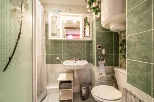 a small bathroom with a sink and a toilet at Appartement Bernex - 3 personnes in Bernex +17 photos