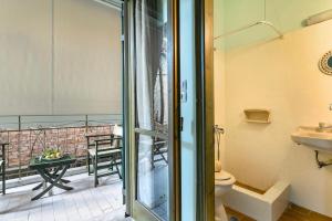 a bathroom with a toilet and a balcony at Old Boat double studio 2 in Nikiana
