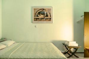 a bedroom with a bed and a picture on the wall at Old Boat double studio 2 in Nikiana
