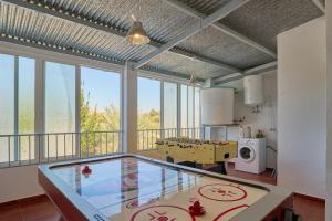 a large kitchen with a glass table in a room at Casa Ángeles in Cuevas Bajas