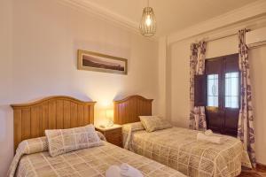 a bedroom with two beds and a window at Casa Ángeles in Cuevas Bajas +34 photos