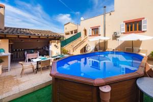 a large swimming pool in the backyard of a house at Casa Hermosa in Capdepera