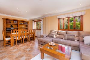 a living room with a couch and a table at Casa Hermosa in Capdepera