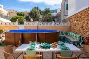 a patio with a table and a swimming pool at Casa Hermosa in Capdepera
