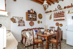 a kitchen and dining room with a table and chairs at Penny 's House in Artemonas +16 photos