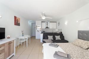 a living room with a bed and a living room with a kitchen at Mareverde K130 in Adeje