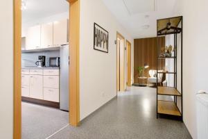 a kitchen with white cabinets and a dining room at Wohnung beim Obsthof in Meckenbeuren