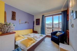 a living room with a couch and a chair at Rebecca's House few steps from skiing - Happy Rentals in Bardonecchia