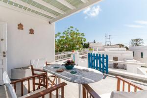 a patio with a table and chairs on a balcony at Penny 's House in Artemonas