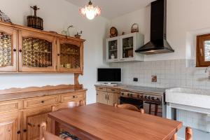 a kitchen with wooden cabinets and a wooden table at Il Cerro Appartamento Basic per due in Pelago