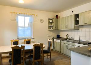 a kitchen with a table and chairs and a dining room at Herrenhaus Gut Buchenhof in Römhild